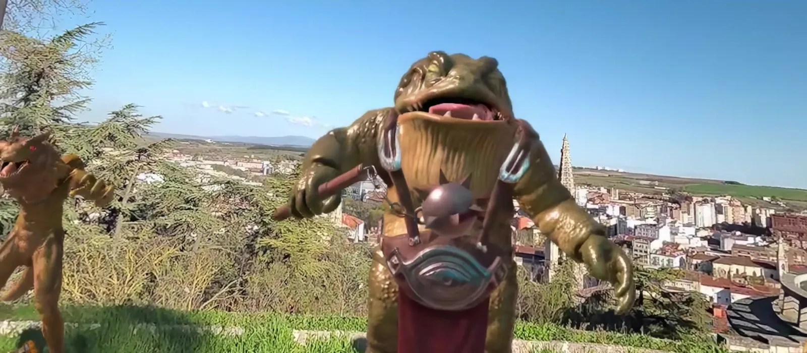 Mixed reality: a giant toad creature on a real hill above a city